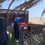 a man cleaning  rest place in the beach