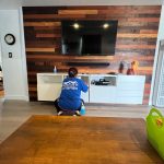 a woman cleaning the shelves and storage compartment in the living room