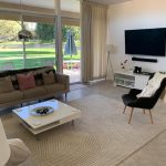 simple living room with a view of its backyard